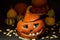 Orange pumpkin with carved eyes, nose and mouth, covered with gray mold