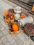 Orange pumpkin, clay jugs lie with straw in wooden boxes, next to iron cans, pumpkins and a basket of lavender