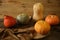 Orange pumpkin and gourds on the wooden rustic table. Thanksgiving Day. Halloween. Harvest. Autumn still life.