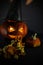 an orange pumpkin for the Halloween holiday with carved features and a pointed black hat