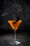 Orange pumpkin martini Halloween drink for party over black background. copy space