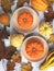 Orange pumpkin surrounded by autumn leaves