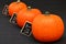 Orange pumpkins on a black background and tablets with the words taste health and diet