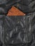 Orange purse in pocket of black leather jacket