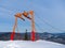 Orange pylon of a ski lift on top of a mountain