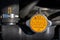 Orange radiator cap with warning labels in different languages: never open when hot, and blurred car radiator hose