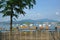 Orange recreational boats on lake, mountains, park fence and tree