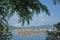 Orange recreational boats on lake, mountains and tree