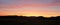 Orange red fiery sunrise sunset over silhouette mountain landscape