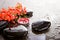 Orange Red Freesia Laxa flowers with black massage stones and re