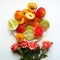 Orange and red fruit on a plate on a white background and a colorful bouquet of flowers next to it. Cheerful of summe