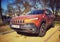 Orange red Jeep Cherokee private car parked