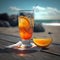 Orange refreshing cocktail on wooden table near sea