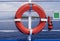 Orange rescue buoy or life ring on the deck of a ferry sailing to Corfu island, Greece. Safety equipment on the ship