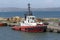 Orange rescue or coast guard patrol boat in blue sea water