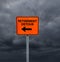 Orange Retirement Detour sign with dark storm clouds