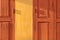 Orange retro thai wooden folding door with yellow wall under evening sunlight