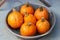 Orange ripe Mandarin pumpkin, heap of pumpkins in a metal bowl