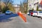 Orange road columns bisect the carriageway in spring sunny day