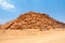 Orange rock formation in dry desert landscape near Twyfelfontein in Damaraland, Namibia