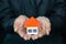 Orange roof houses on the hands of businesses and investors in buying a home purchase contract with a broker or real estate agent