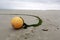 Orange round buoy on sand beach in low season