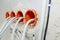 Orange, round junction box mounted in the white wall with protruding electric cables.