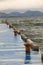 orange Rusty bollards on blue pier