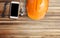 Orange safety helmet,glasses,earphone and smart phone on brown wood table background