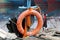 Orange safety life ring hanging on fishing boat masts