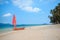 Orange sailboat on the beach