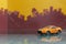 Orange saloon car toy selective focus on blur city background