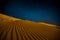 Orange sand dunes at night