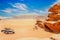 Orange sands and rocks of Wadi Rum desert with cars in foreground, Jordan