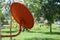 Orange satellite dish for receiving  signal next to the roof of the house for good signal reception Rural forest background