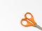 Orange scissor with white background.