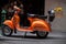 Orange Scooter with Orange Marigolds in Wooden box.