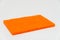Orange Scouring pad with white background and selective focus