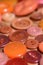 Orange sewing buttons on a wood table