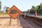 The orange sign shows the machine symbol being operating on the side of the road.