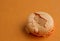 Orange single crushed macaroon over orange background