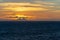 Orange skies sunset behind mountains in Morocco viewed from the Strait of Gibraltar.