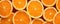 Orange sliced background. Oranges cut on orange table