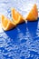 Orange slices on blue surface