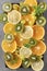 Orange slices, lemon, mint, sprig , green grapes, kiwi, on a grey background ,fresh citrus and fruit