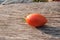 Orange, small tomato on a wooden background; delicious for salads; horizontal photo, object in the center