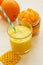 Orange smoothie in a glass. Candied kumquat.