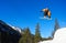 Orange snowboarder jumping high