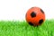 Orange soccer ball on grass