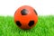 Orange soccer ball on grass